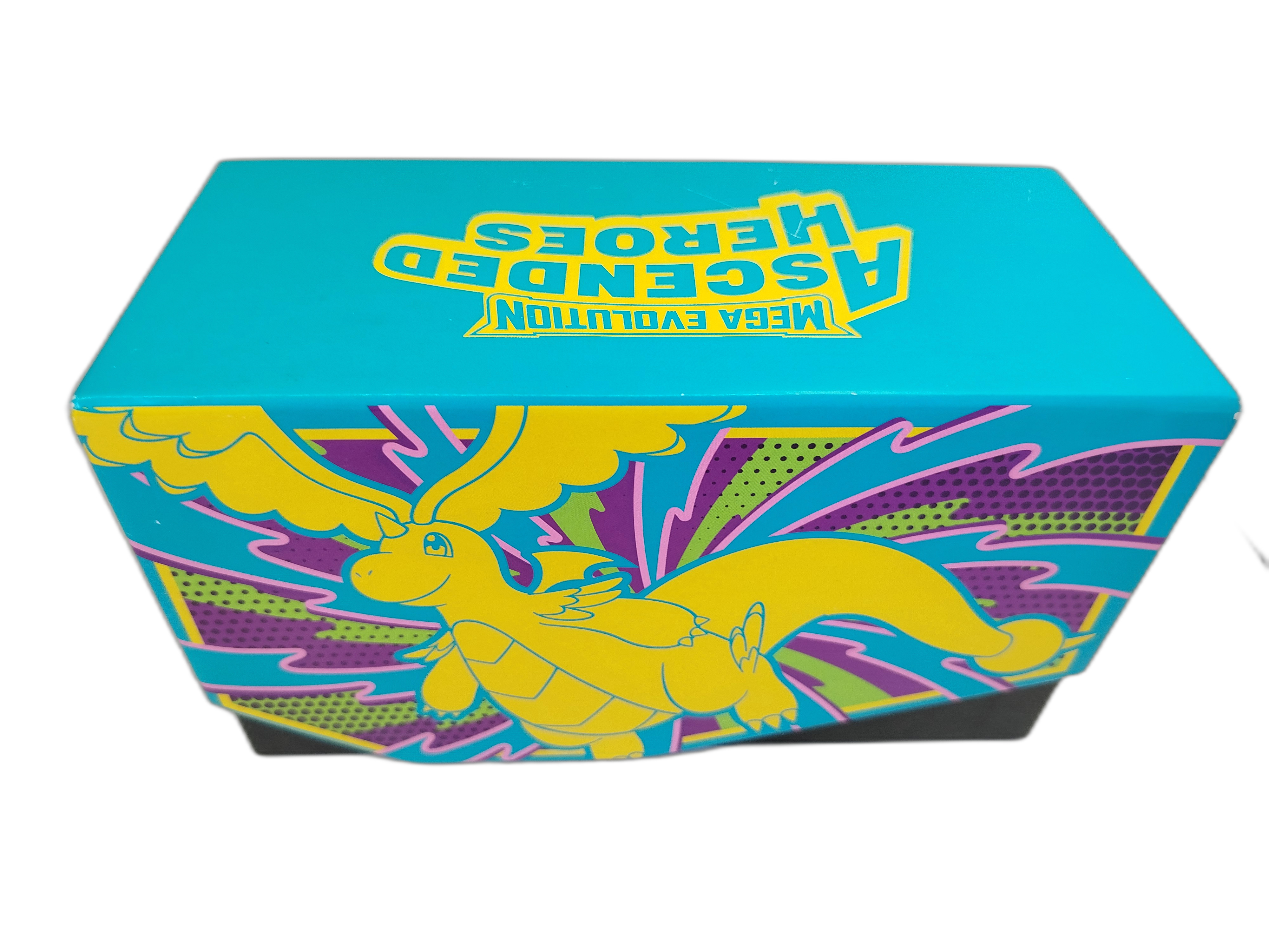 Pokemon - Caja de carton cuenta con un llamativo color azul turquesa y la silueta en tono amarillo de Mega-Dragonite