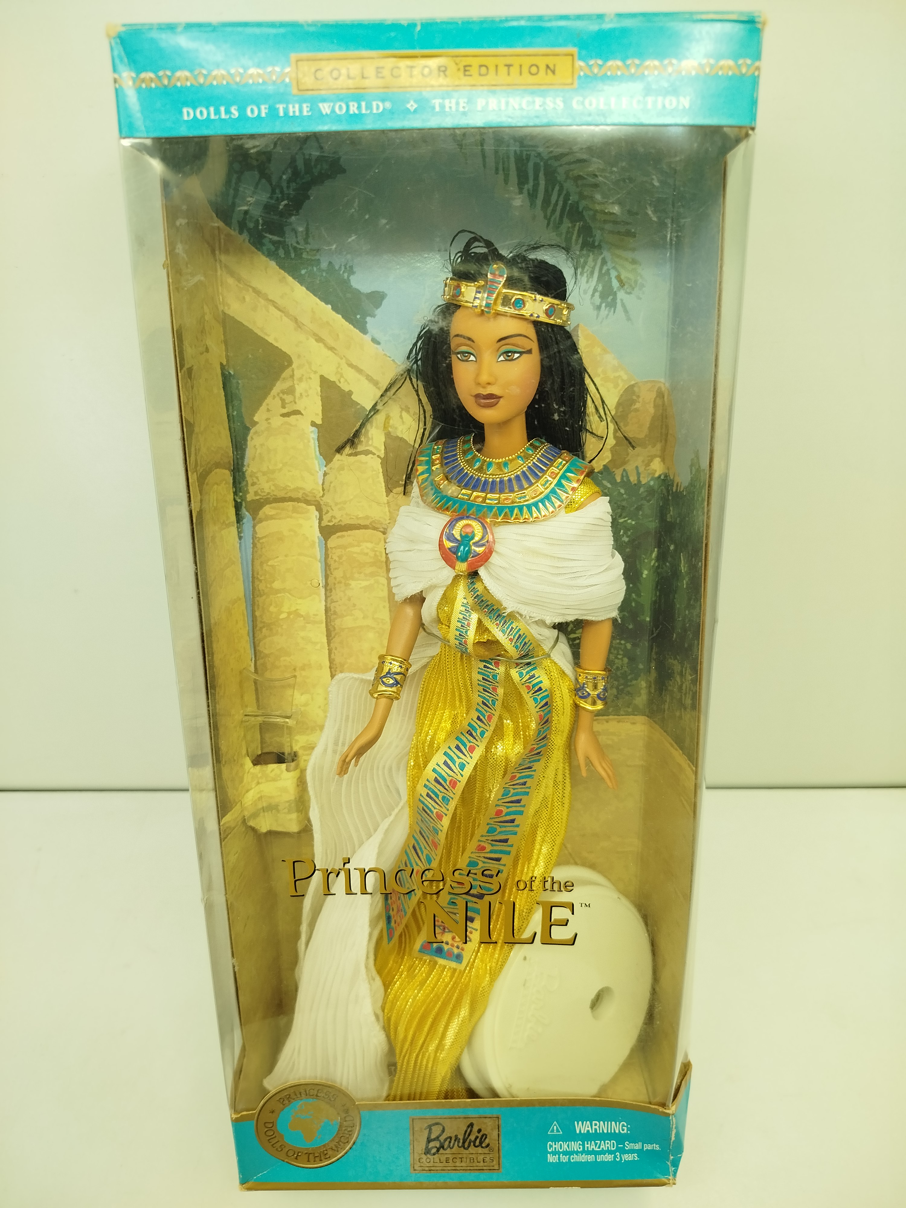 Barbie -  Esta imagen corresponde a la muñeca Princess of the Nile Barbie, que forma parte de la serie The Princess Collection dentro de la línea Dolls of the World de Mattel