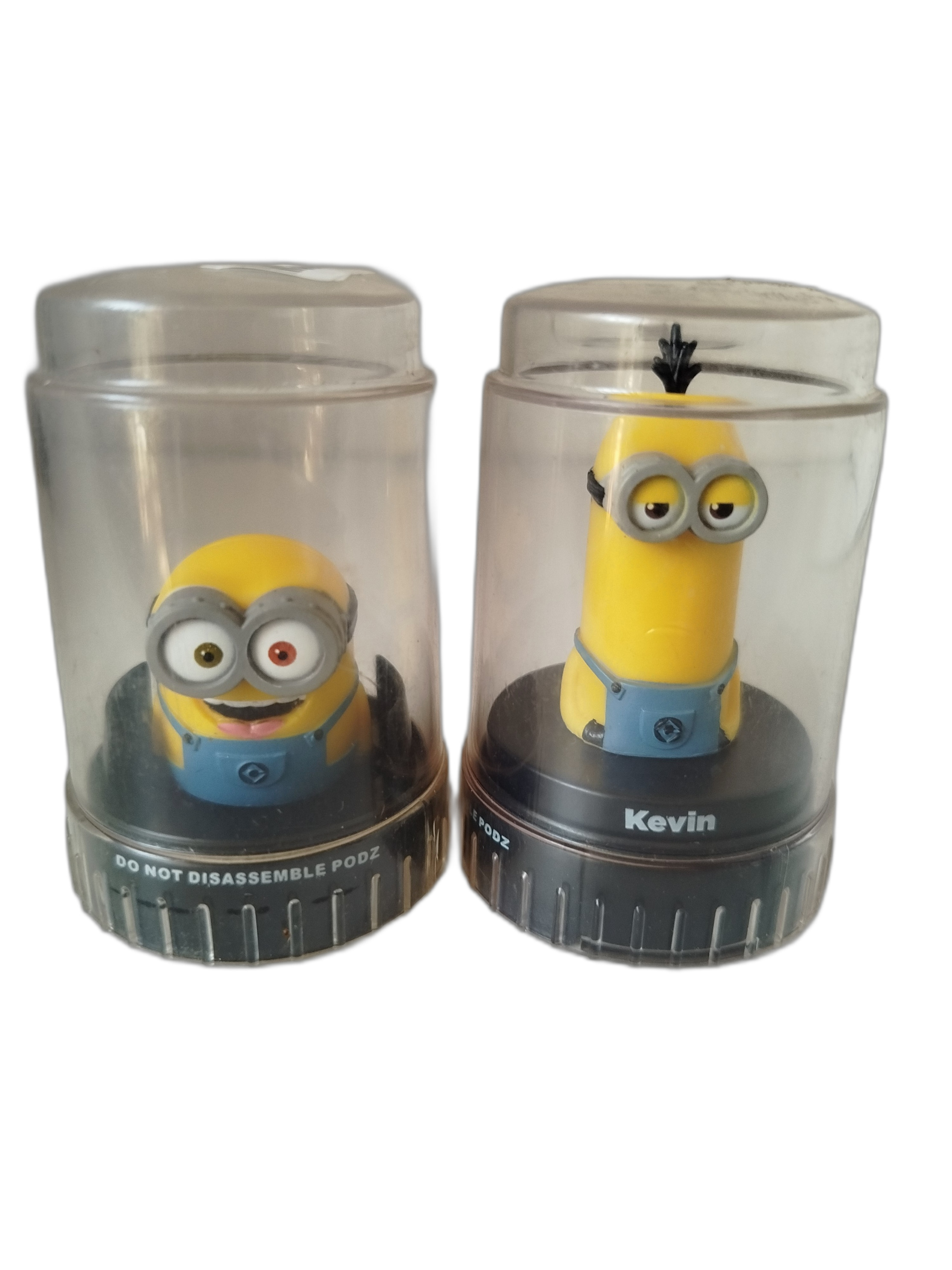 2 PODZ - Minions - Cápsulas  transparentes con base negra